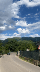 Mountain road traffic and bookstore display captured in Italian town