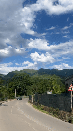 Mountain road traffic and bookstore display captured in Italian town