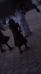 Family gathering features dancing on outdoor patio in Jos