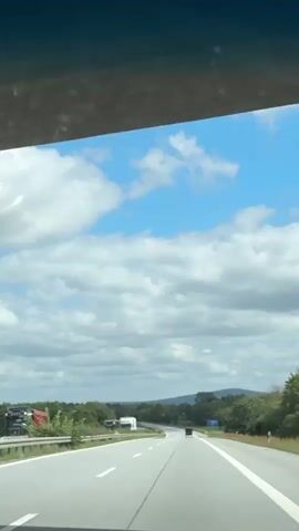 A video taken from inside a vehicle driving on a highway. The highway has multiple lanes and is bordered by trees and vegetation. The sky is blue with white clouds. Several trucks and cars are visible on the highway. The camera perspective is from the front passenger seat, looking out the windshield. The time stamp on the video indicates it was recorded on September 16, 2019, at 10:17 AM.
