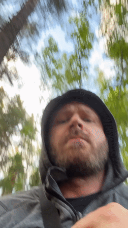 Man records video message in Russian forest