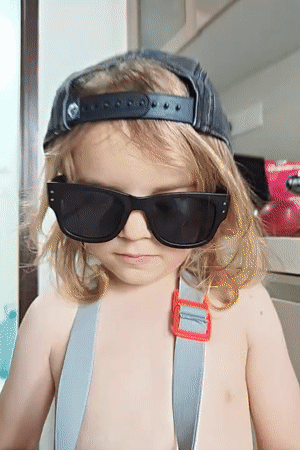 Child in sunglasses and cap spotted indoors in Mumbai