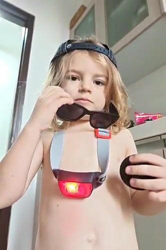 Child in sunglasses and cap spotted indoors in Mumbai