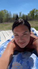 Woman sunbathes on deck in Пастухово, Russia