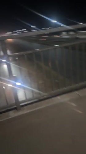 Nighttime traffic observed from pedestrian bridge in Kuchingoro, Nigeria