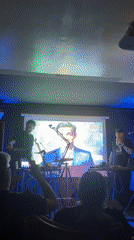 Live music performance captured at dimly lit Rome venue
