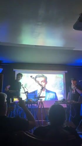Live music performance captured at dimly lit Rome venue