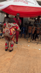 Woman dances at outdoor band performance in Onitsha