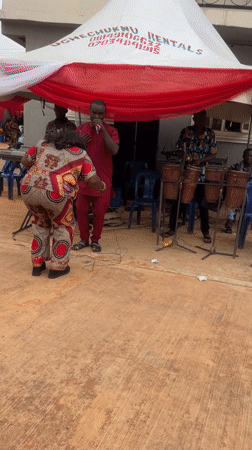 Woman dances at outdoor band performance in Onitsha