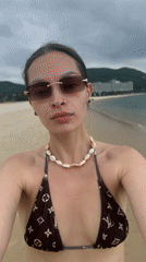 Woman documents beach visit with selfies and coastal footage