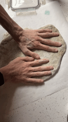 Late-night pizza making session documented in New York kitchen