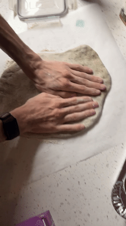 Late-night pizza making session documented in New York kitchen