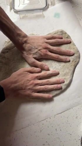 Late-night pizza making session documented in New York kitchen