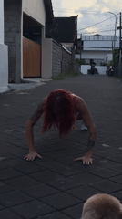 Woman performs street workout in North Kuta, Indonesia