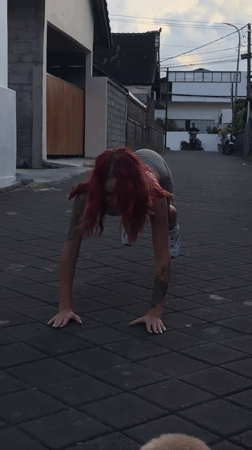Woman performs street workout in North Kuta, Indonesia