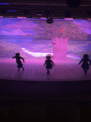 Traditional folk performance on a painted-backdrop stage in Bolshoy Kichmai