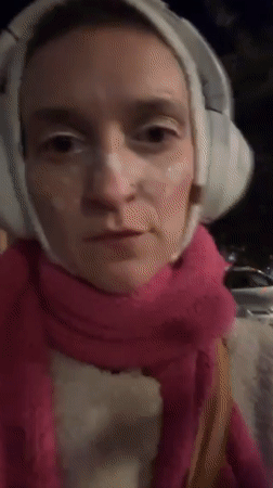 Glittery pedestrian walks Batumi street at night