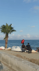 Yenişehir's sunny waterfront promenade on a calm afternoon