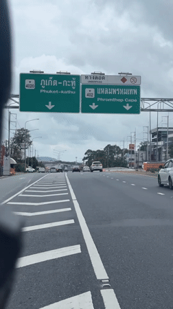 Motorcycle rider travels highway in Ratsada, Thailand
