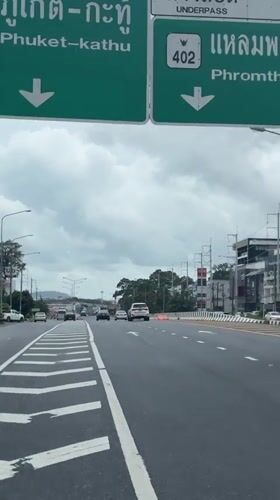 Motorcycle rider travels highway in Ratsada, Thailand