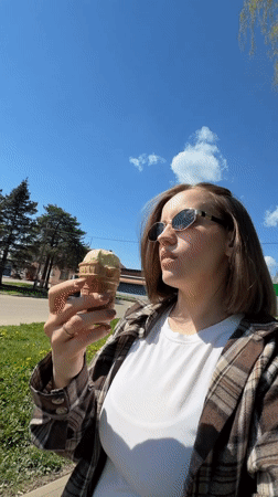 Woman enjoys ice cream outing with baby in Reshetnikovo
