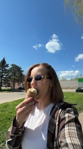 Woman enjoys ice cream outing with baby in Reshetnikovo