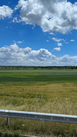 Traveler photographs scenic Bulgarian landscape from moving vehicle window