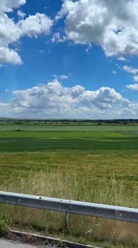 Traveler photographs scenic Bulgarian landscape from moving vehicle window