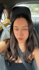 Woman takes selfies in car driver's seat in Puebla