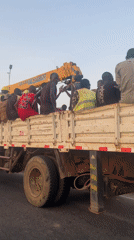 Flatbed truck carries passengers on busy Abuja roads