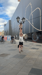 Young women perform acrobatics on Moscow sidewalk