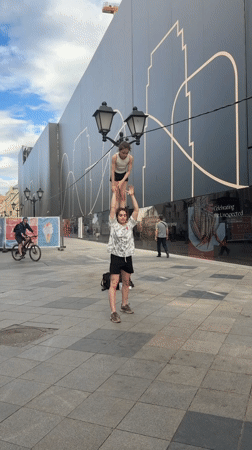 Young women perform acrobatics on Moscow sidewalk