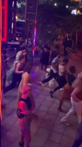 Crowd dances in formation at nighttime gathering in Accra