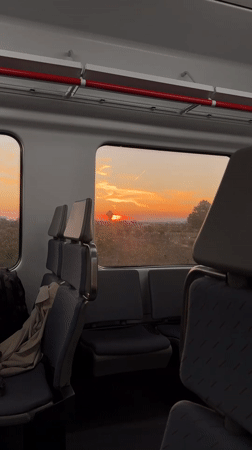 Passenger captures sunset view from empty train in Spain