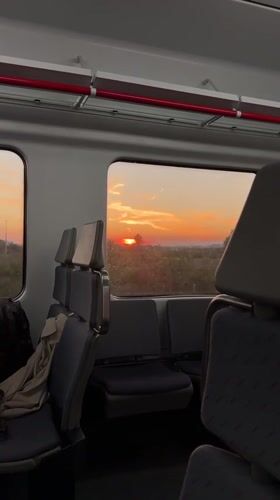 Passenger captures sunset view from empty train in Spain