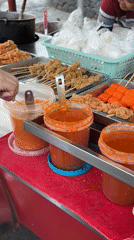 Street food vendors serve customers near Davao City landmark