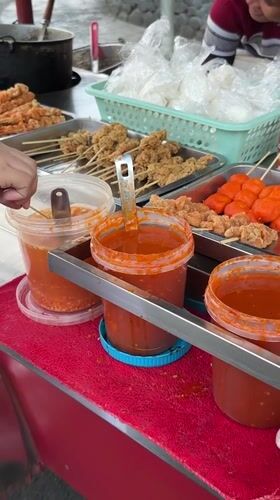 Street food vendors serve customers near Davao City landmark