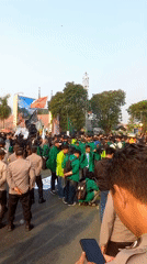 Green-clad crowd rallies in Samarinda with flags and police present
