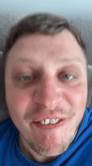 Man makes exaggerated faces at camera while on couch