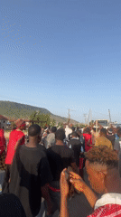 Large crowd gathers with sticks in Lokoja, Nigeria streets