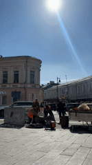 Construction crew works on cylindrical object in Moscow square