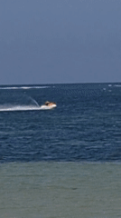 Denpasar coastline alive with boats, watersports, and beach activity