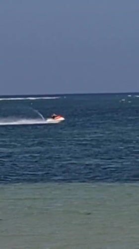 Denpasar coastline alive with boats, watersports, and beach activity