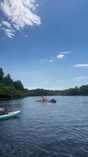 Handstand on a paddleboard, sunny lake day in Russia