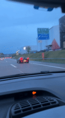 Black sports car spotted on rainy Swiss highway