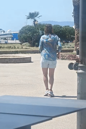 Woman celebrates with phone in Bar Montenegro square