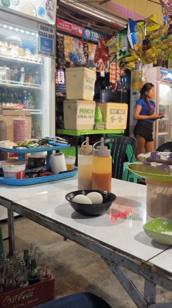 Night food stall in Carmen sells eggs, rice cakes, and snacks