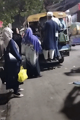 Crowded auto-rickshaw spotted on illuminated evening street