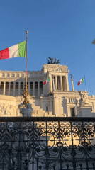 Tourist documents Rome's Vittoriano monument during evening visit