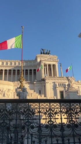 Tourist documents Rome's Vittoriano monument during evening visit